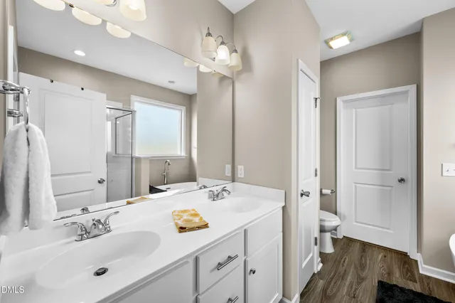 a bathroom with a sink a toilet a tub and shower