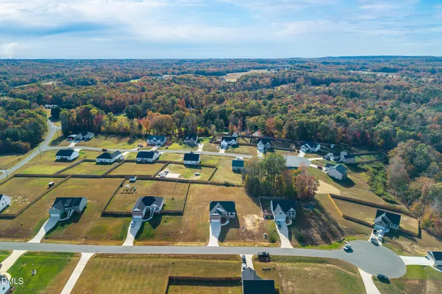an aerial view of a house with a swimming pool