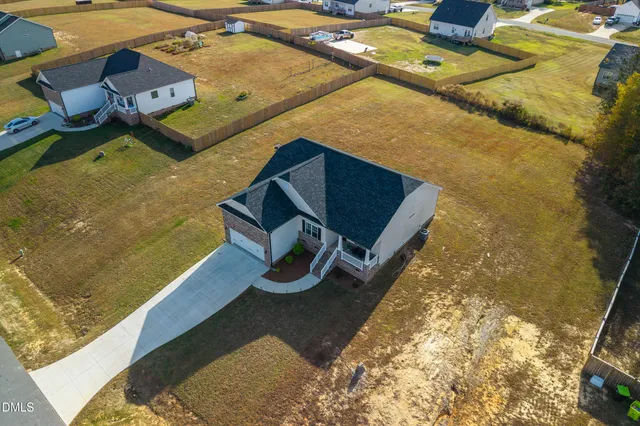 an aerial view of residential houses with outdoor space