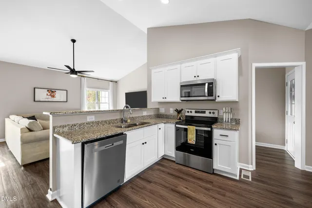 a kitchen with granite countertop a stove top oven and sink