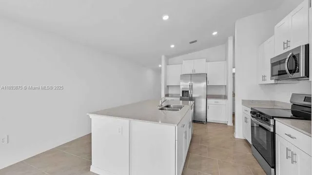 a kitchen with stainless steel appliances a stove microwave and refrigerator