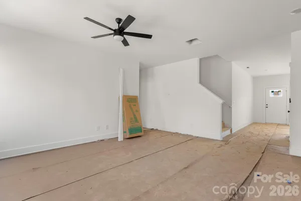 a view of a livingroom with a ceiling fan and window