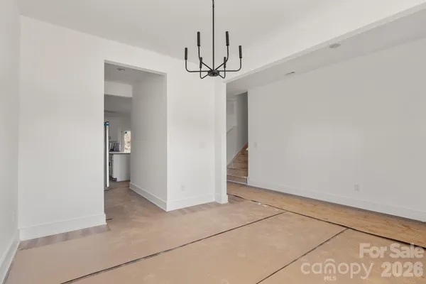 a view of a chandelier fan and entryway