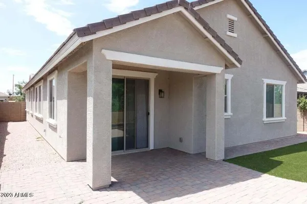 a view of a house with a wooden bench in front of door