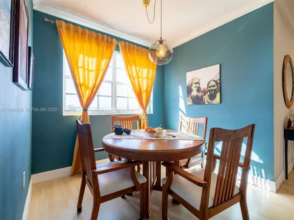 a dining room with furniture and window