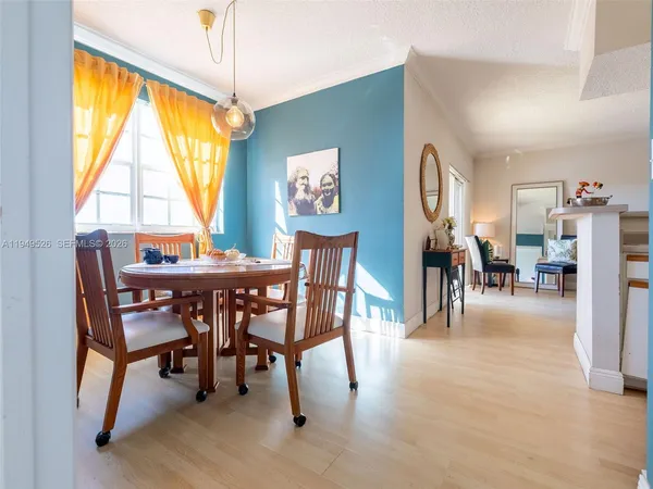 a dining room with furniture and a window