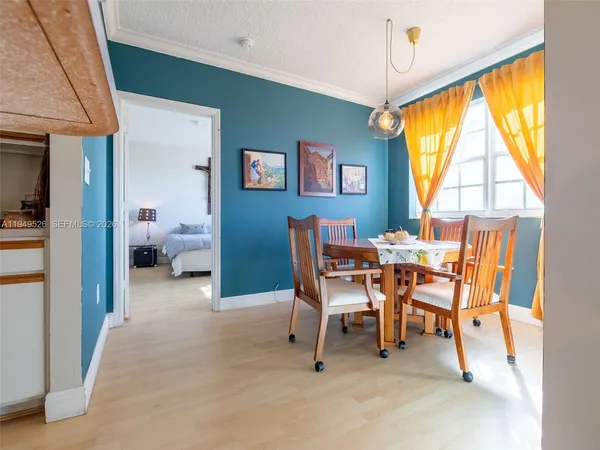 a view of a dining room with furniture and a window