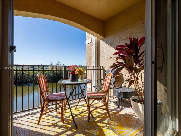 a view of a chairs and table in patio with a backyard