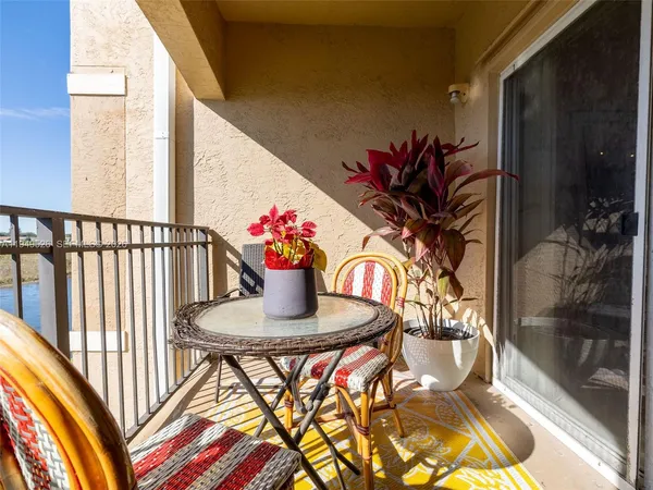 a dining room with furniture and a potted plant