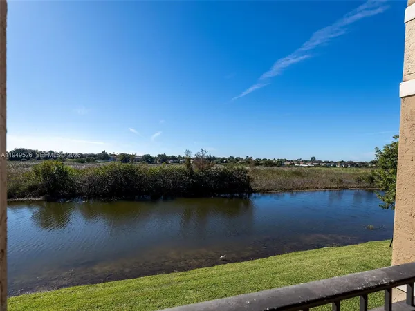 a view of a lake with houses in the back