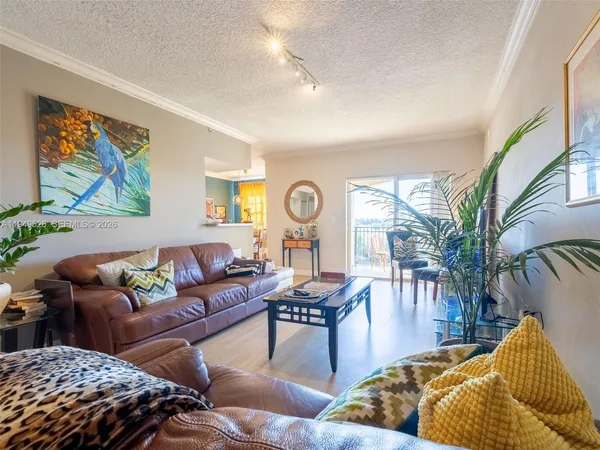 a living room with furniture and painting on the wall
