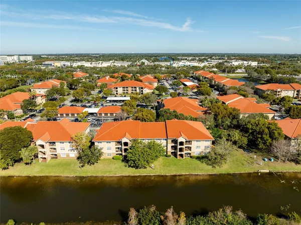 an aerial view of residential building and lake