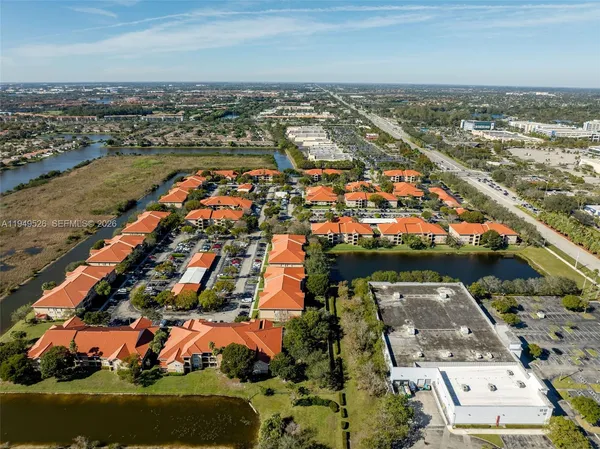 an aerial view of residential building and lake