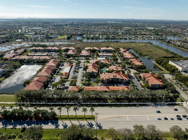 an aerial view of residential building and lake