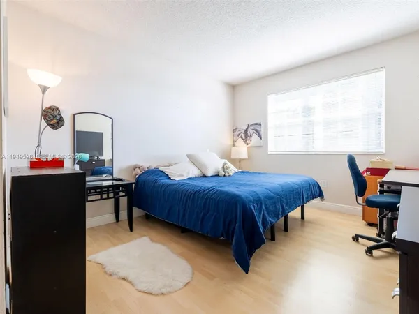 a bedroom with a bed and a table in it