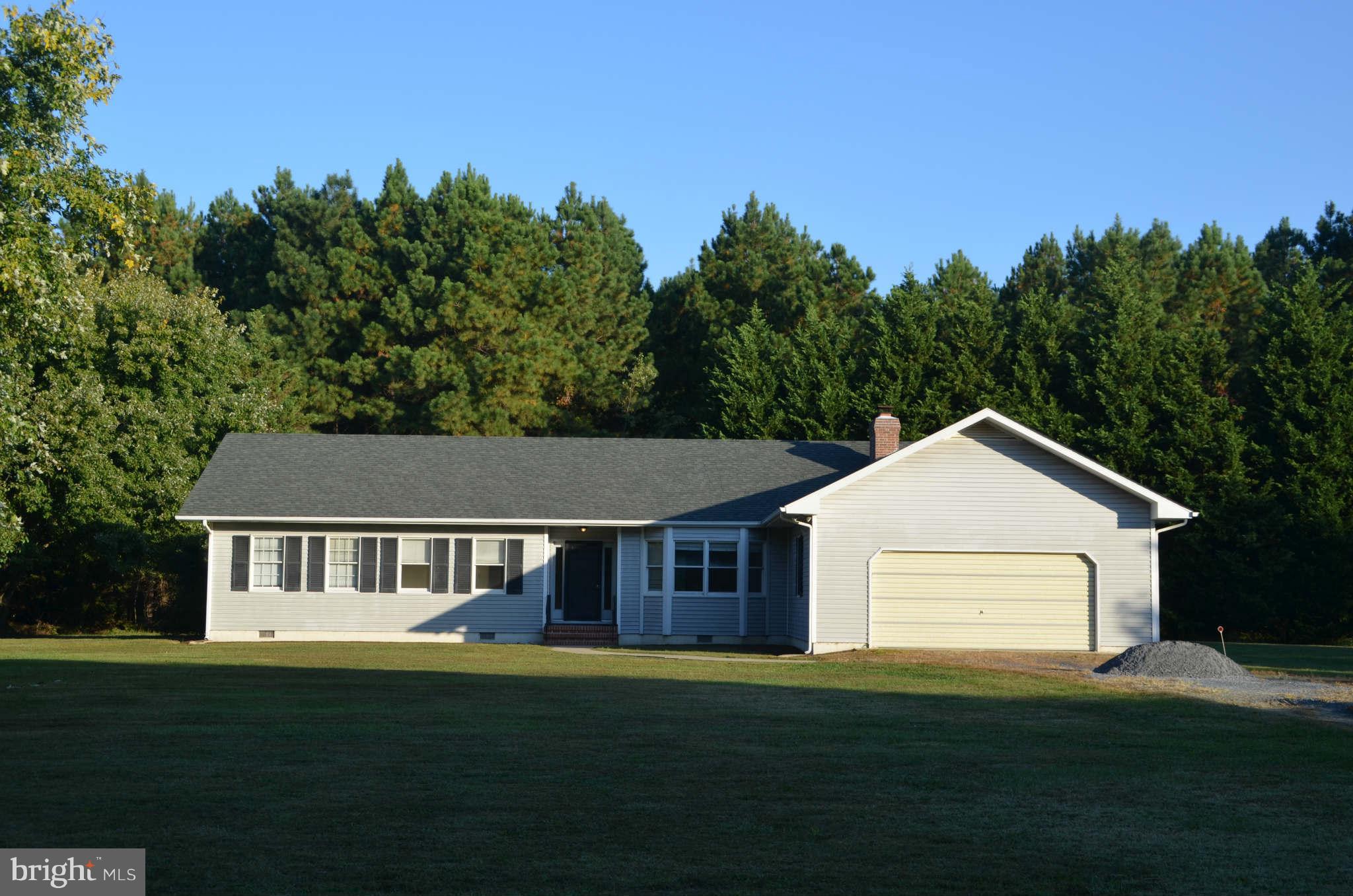 6922 Thorneton Road St. Michaels, MD 21663 - Photo 1 of 26 a aerial view of a white house next to a yard with large trees