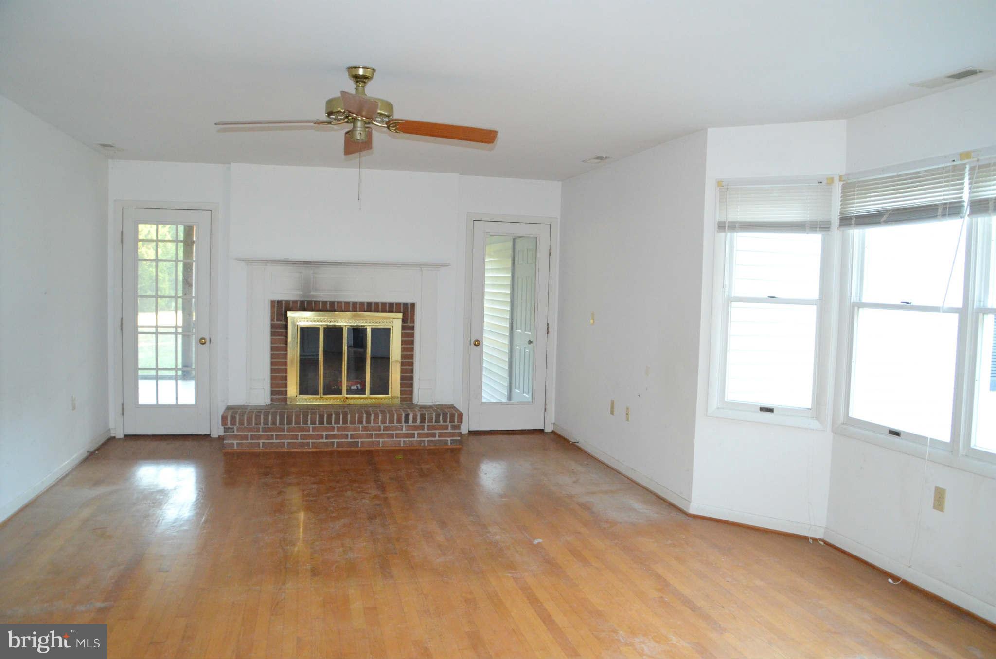 6922 Thorneton Road St. Michaels, MD 21663 - Photo 11 of 26 an empty room with wooden floor and windows