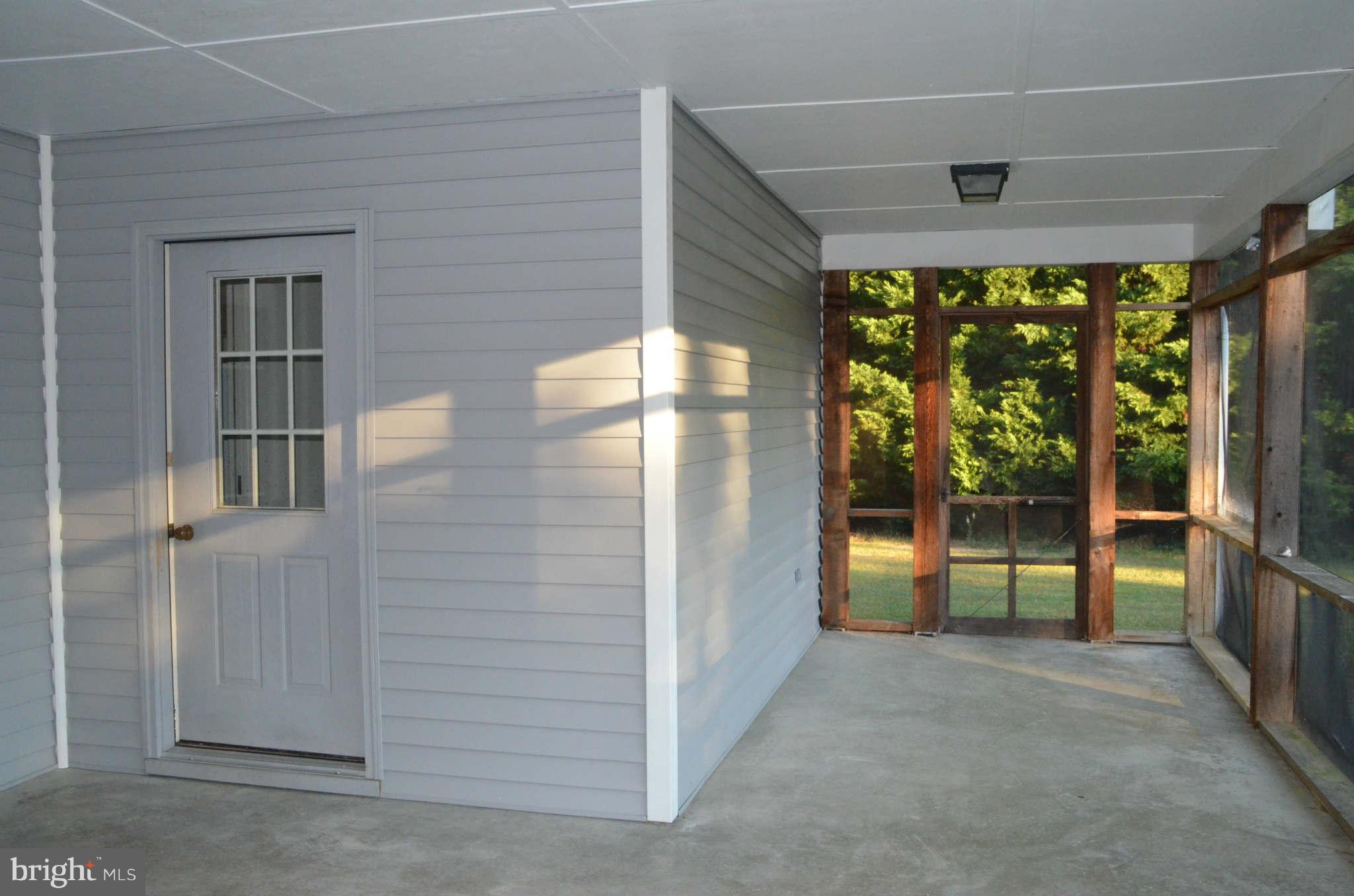6922 Thorneton Road St. Michaels, MD 21663 - Photo 14 of 26 an empty room with floor to ceiling windows and an outdoor view