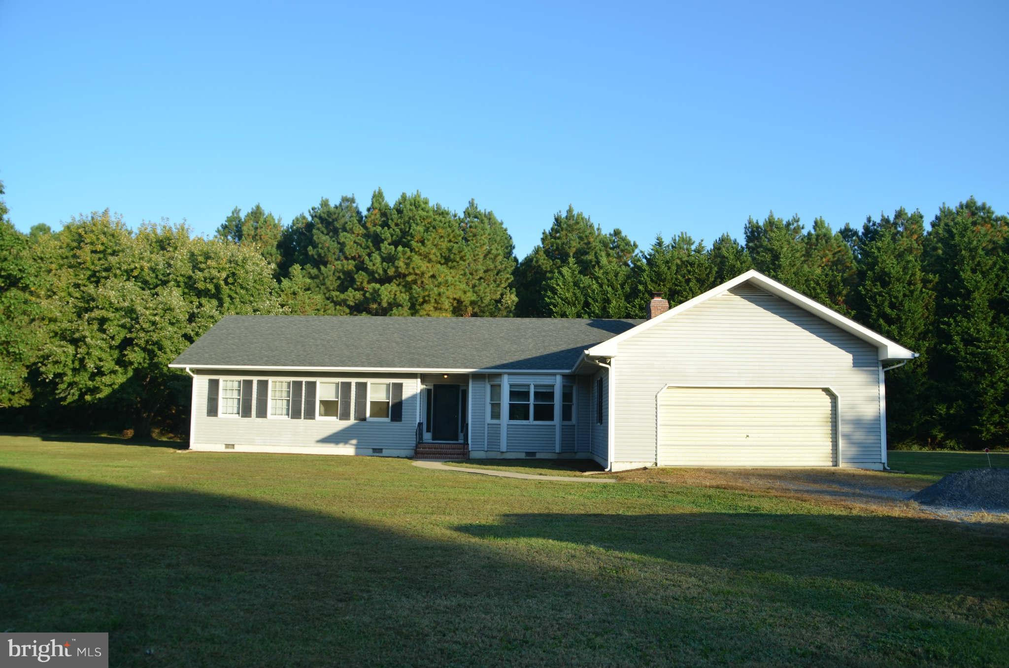 6922 Thorneton Road St. Michaels, MD 21663 - Photo 22 of 26 a front view of a house with a garden and yard