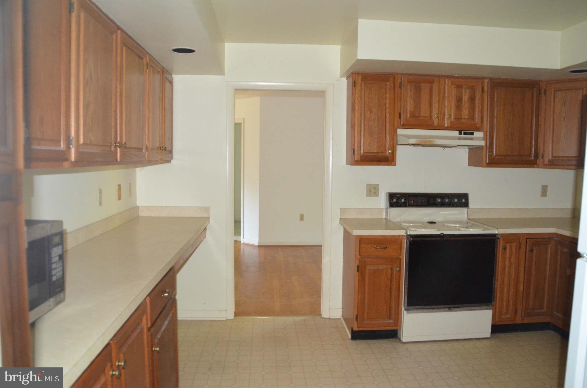 6922 Thorneton Road St. Michaels, MD 21663 - Photo 8 of 26 a kitchen with stainless steel appliances granite countertop a stove and a refrigerator