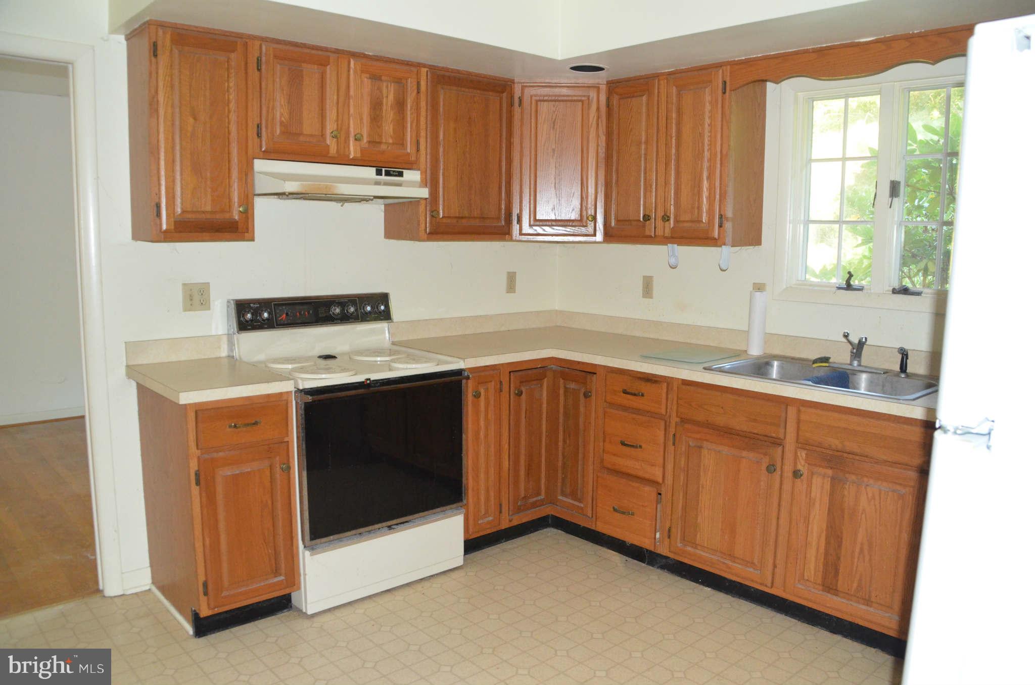 6922 Thorneton Road St. Michaels, MD 21663 - Photo 9 of 26 a kitchen with stainless steel appliances granite countertop a stove a sink and a microwave