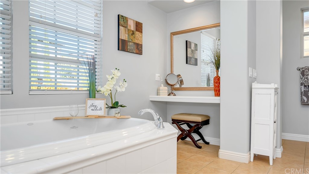 3 Adele Street Ladera Ranch, CA 92694 - Photo 14 of 42 a en suite bathroom with a bathtub and a window