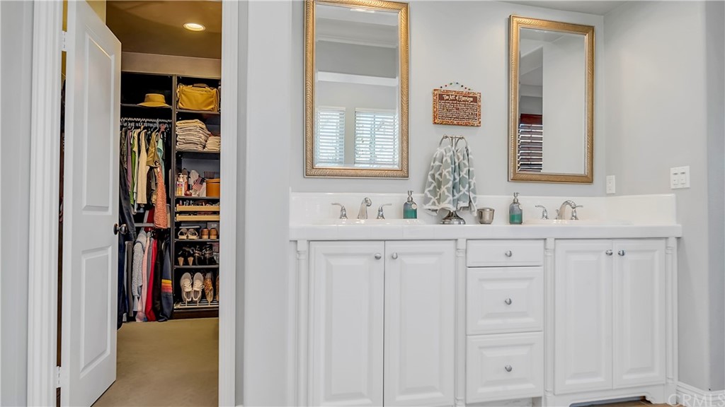 3 Adele Street Ladera Ranch, CA 92694 - Photo 15 of 42 a bathroom with a double vanity sink and a mirror