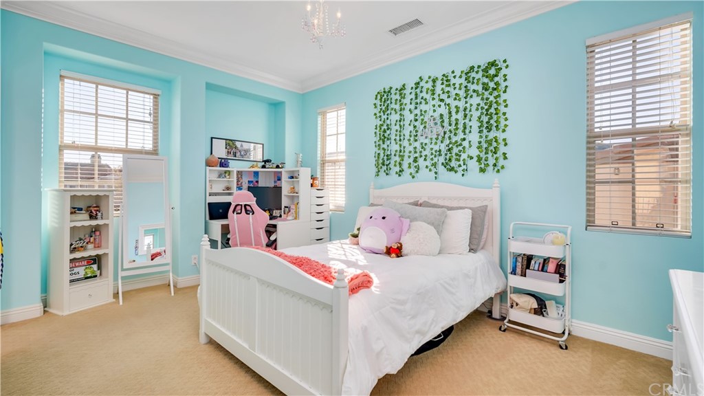 3 Adele Street Ladera Ranch, CA 92694 - Photo 16 of 42 a bedroom with a bed and a book shelf