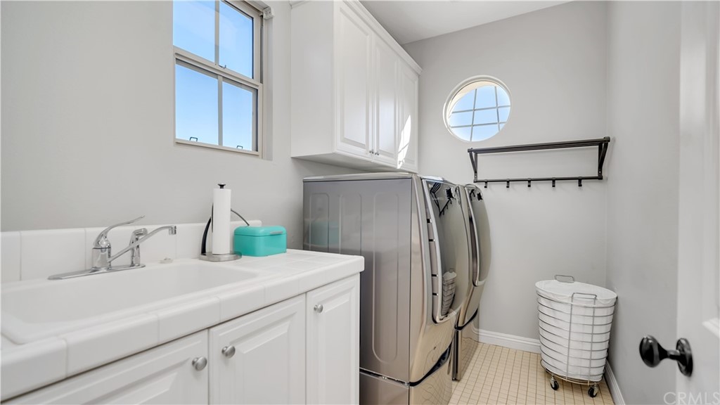 3 Adele Street Ladera Ranch, CA 92694 - Photo 23 of 42 a bathroom with a sink a mirror and a shower