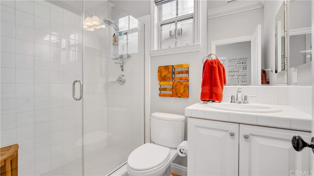 3 Adele Street Ladera Ranch, CA 92694 - Photo 25 of 42 a bathroom with a sink vanity mirror and toilet