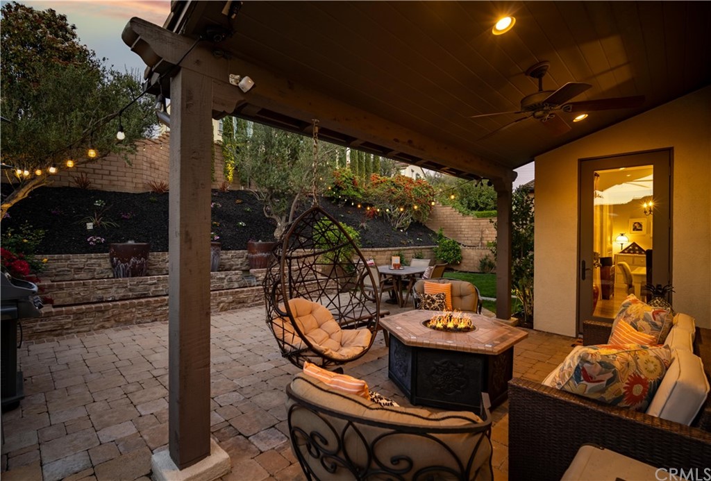 3 Adele Street Ladera Ranch, CA 92694 - Photo 28 of 42 a living room with patio furniture and a floor to ceiling window