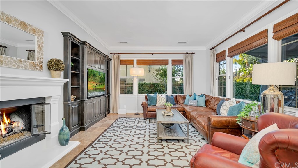 3 Adele Street Ladera Ranch, CA 92694 - Photo 6 of 42 a living room with furniture a fireplace a flat screen tv and a large window