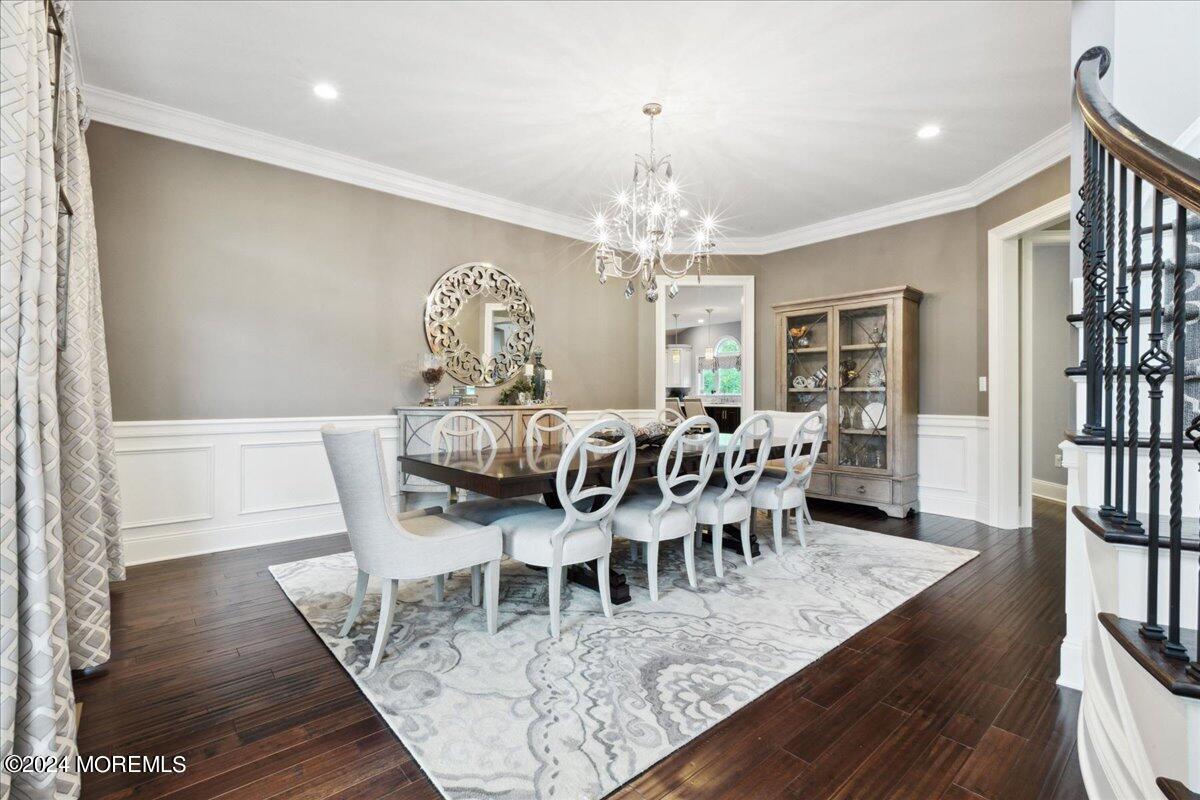 34 Windermere Road Lincroft, NJ 07738 - Photo 17 of 78 a view of a dining room with furniture wooden floor and a chandelier