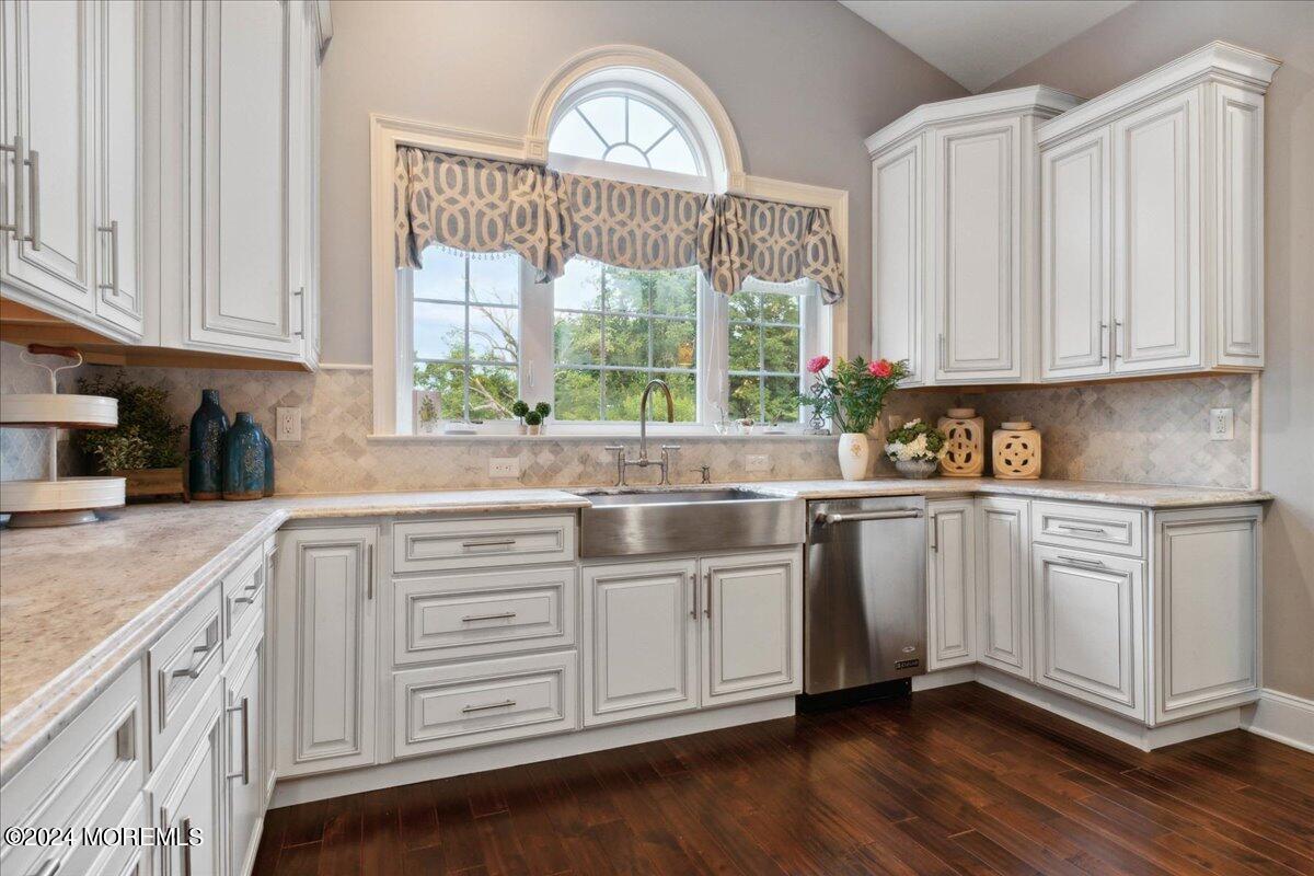 34 Windermere Road Lincroft, NJ 07738 - Photo 28 of 78 a kitchen with stainless steel appliances granite countertop white cabinets a sink and a large window