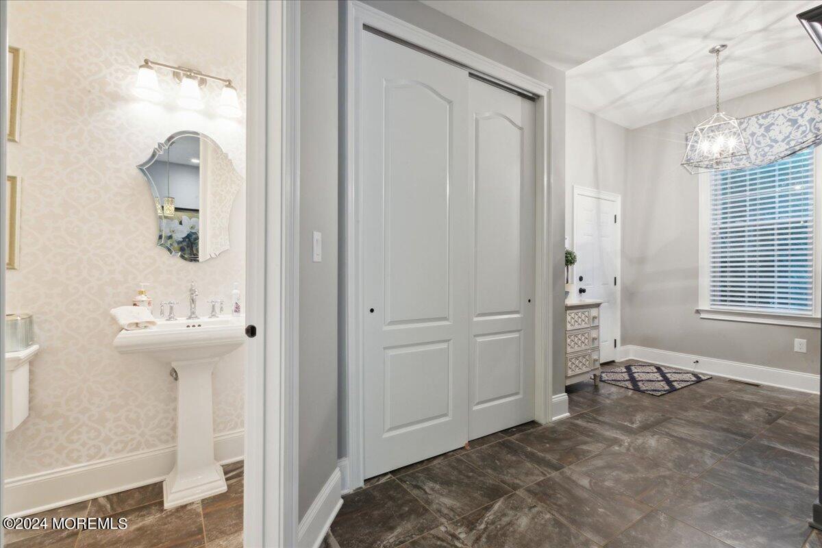 34 Windermere Road Lincroft, NJ 07738 - Photo 31 of 78 a view of a bathroom with a sink and mirror
