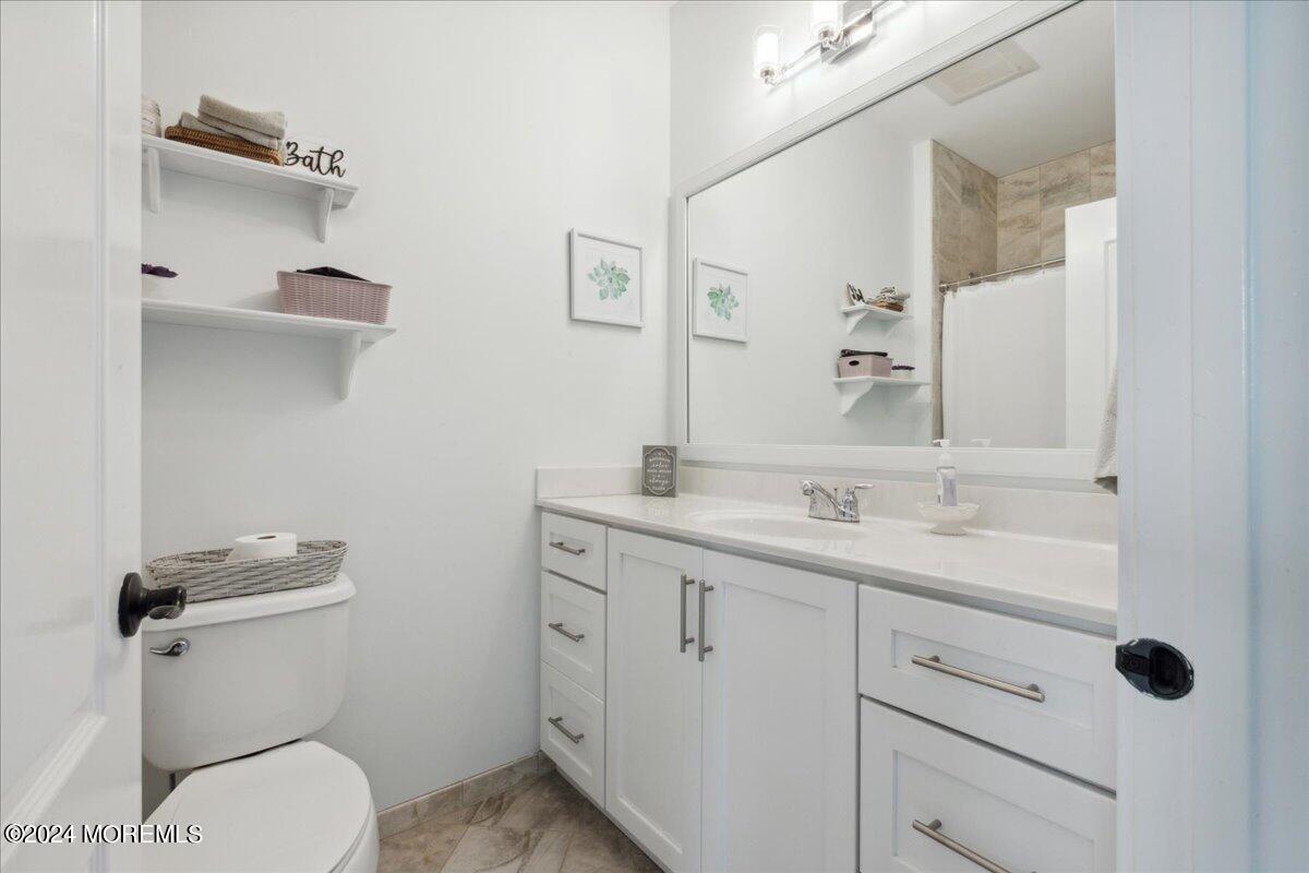 34 Windermere Road Lincroft, NJ 07738 - Photo 43 of 78 a bathroom with a granite countertop toilet sink and mirror