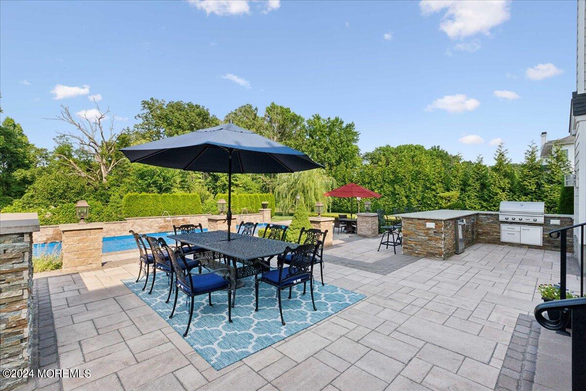 34 Windermere Road Lincroft, NJ 07738 - Photo 57 of 78 an outdoor space with furniture and umbrella