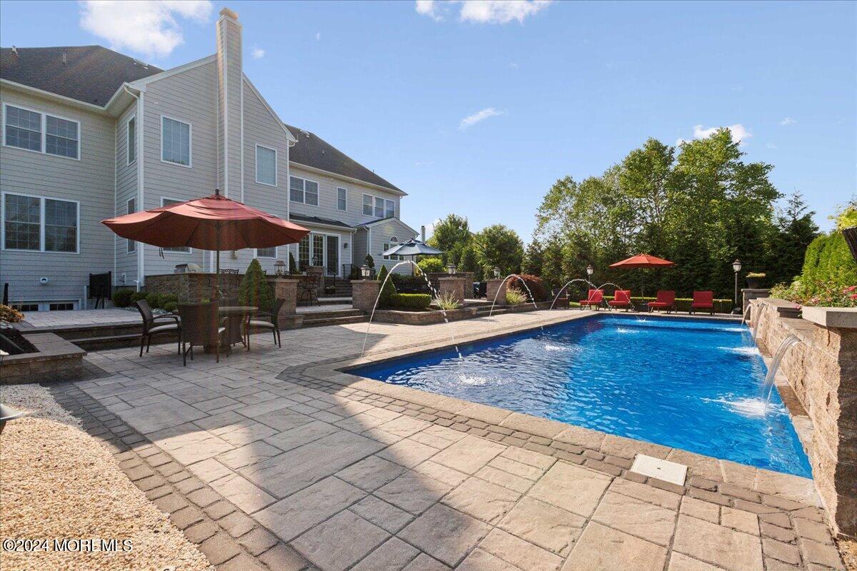 34 Windermere Road Lincroft, NJ 07738 - Photo 60 of 78 a swimming pool with outdoor seating