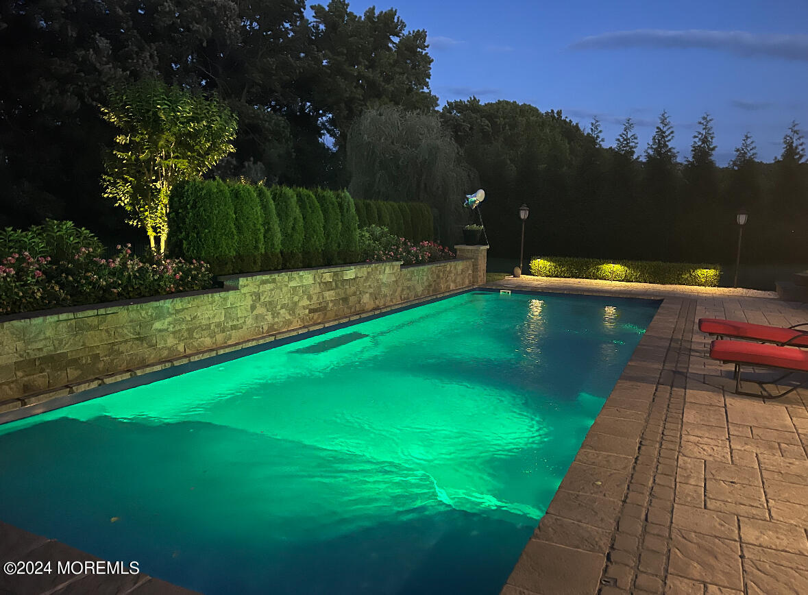 34 Windermere Road Lincroft, NJ 07738 - Photo 63 of 78 a view of a swimming pool with a garden