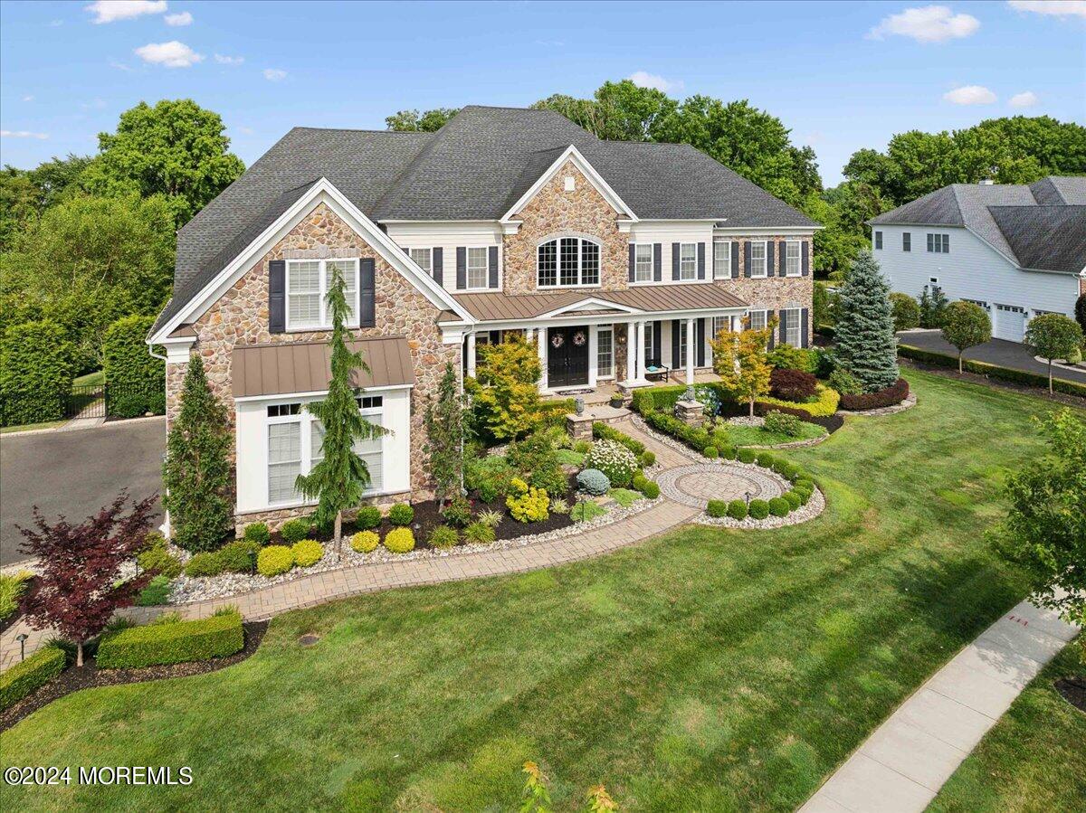 34 Windermere Road Lincroft, NJ 07738 - Photo 65 of 78 a front view of a house with a garden and porch