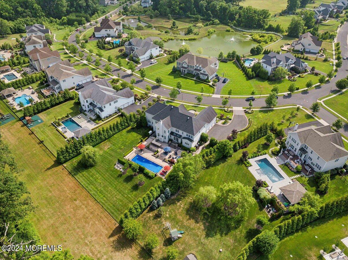 34 Windermere Road Lincroft, NJ 07738 - Photo 67 of 78 an aerial view of residential houses with outdoor space and swimming pool
