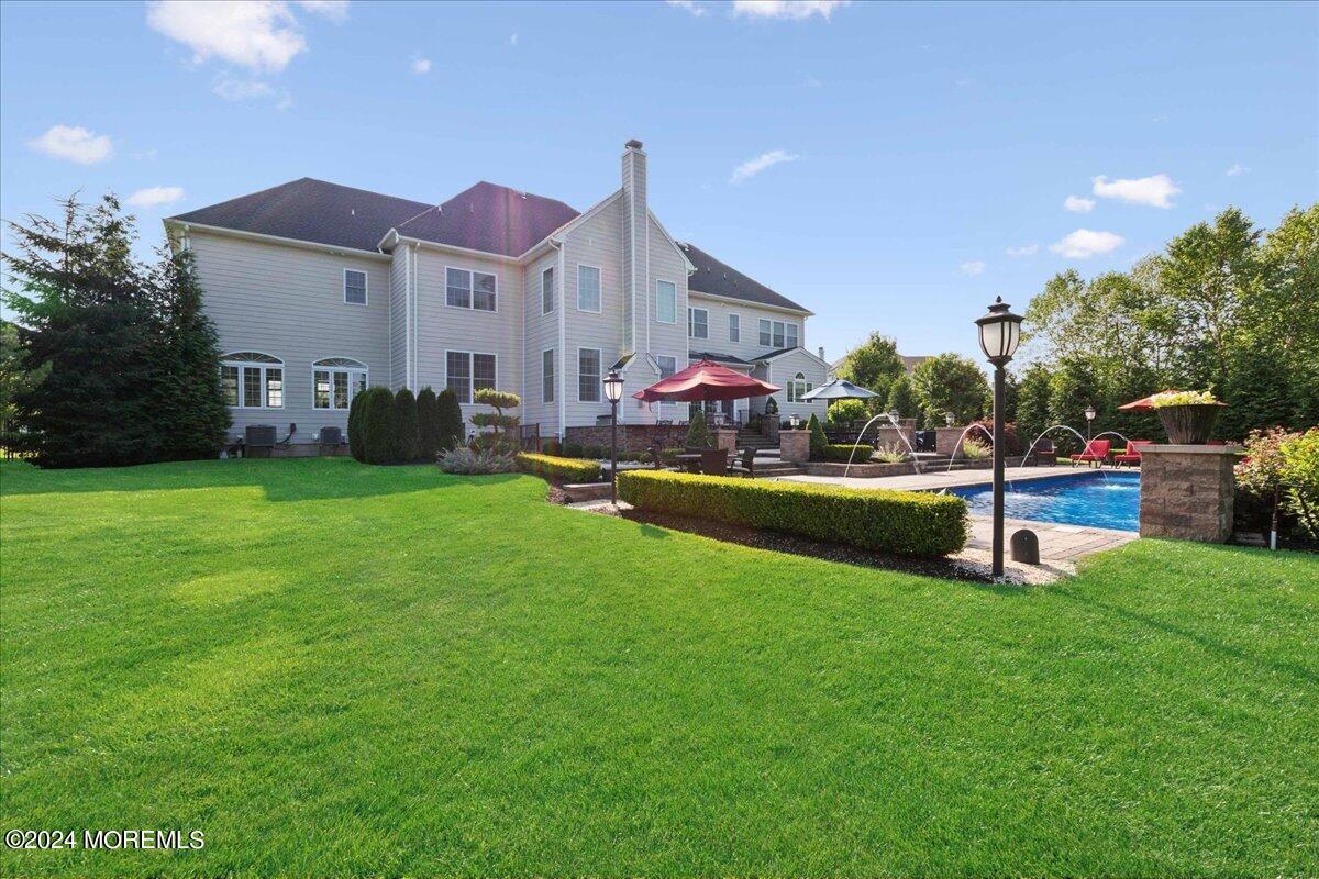 34 Windermere Road Lincroft, NJ 07738 - Photo 75 of 78 a view of a house with a big yard and a large tree center
