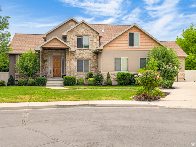 1279 West 1500th Street North Mapleton, UT 84664 - Photo 2 of 83 Stone and stucco exterior featuring a prominent gabled entry with a solid wood front door