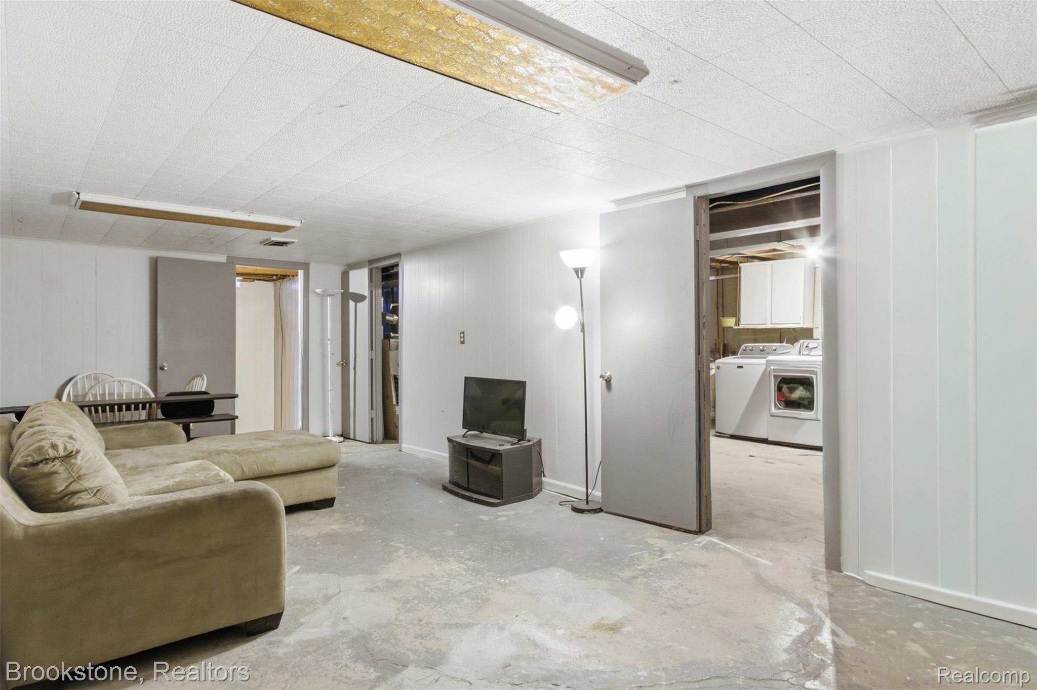 520 May Road Rochester, MI 48307 - Photo 17 of 19 Finished lower level space featuring a drop tile ceiling and concrete flooring
