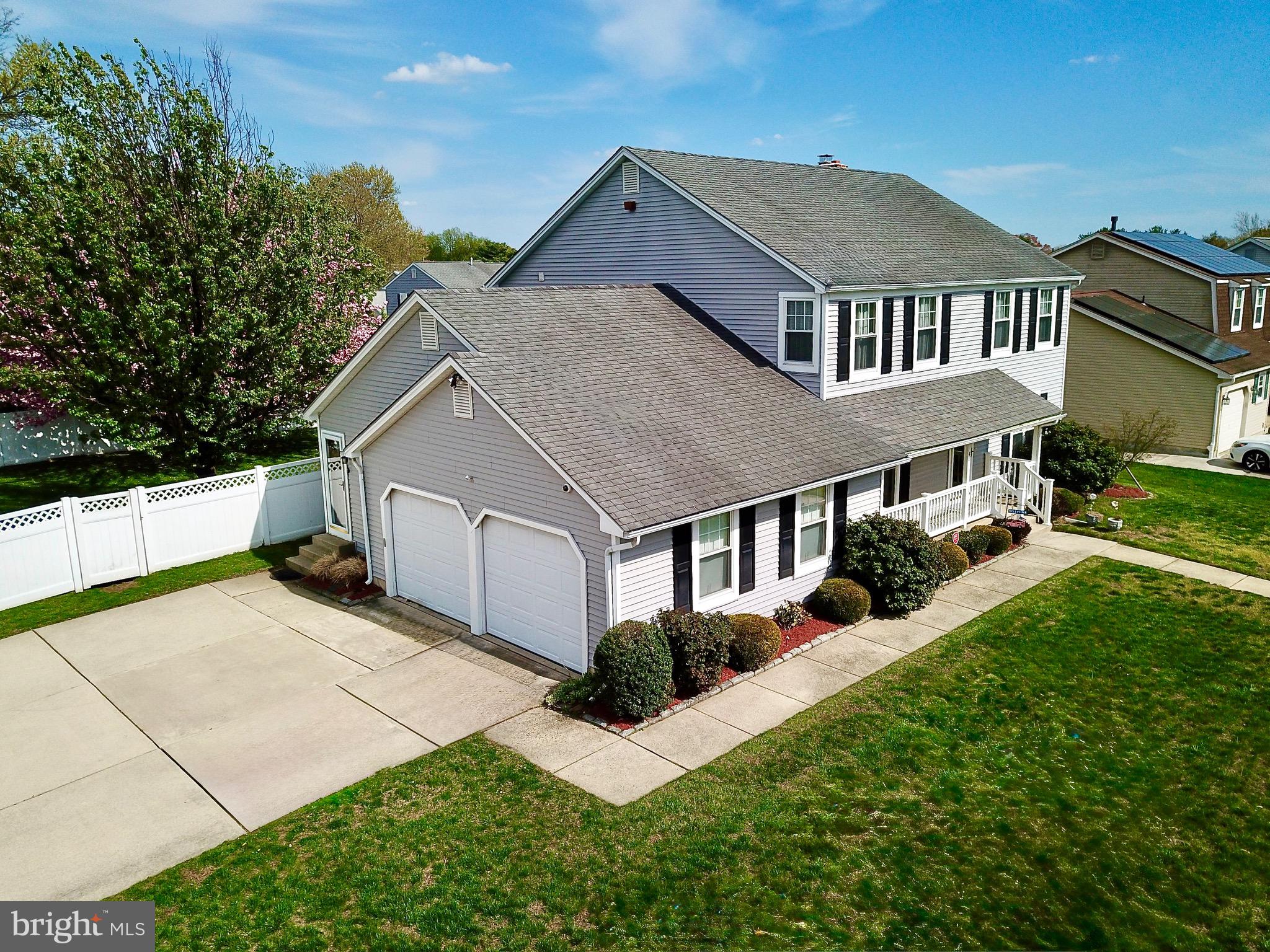 a aerial view of a house with yard and porch