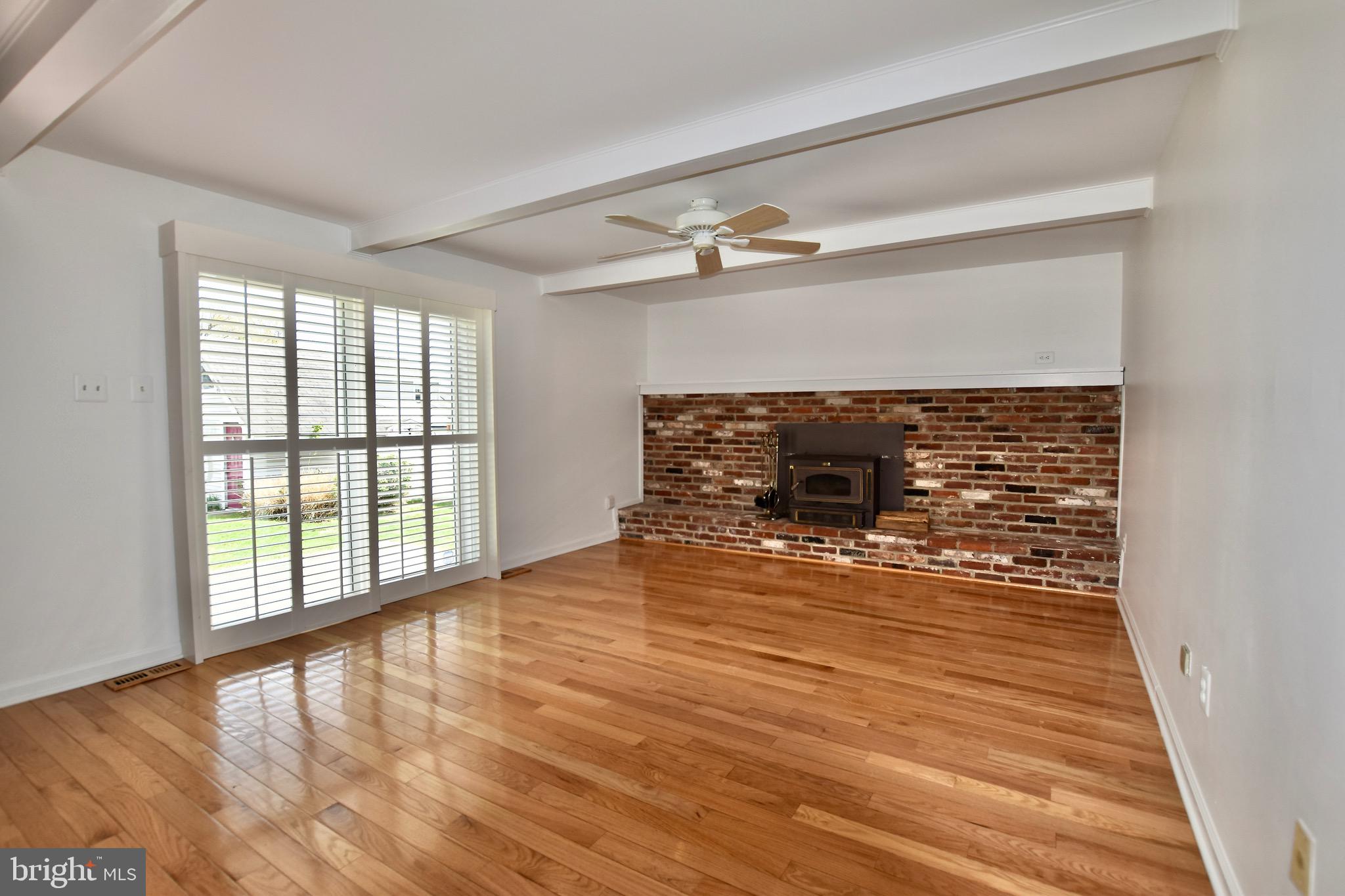 44 West Brookline Drive Laurel Springs, NJ 08021 - Photo 12 of 39 a view of empty room with wooden floor and fireplace