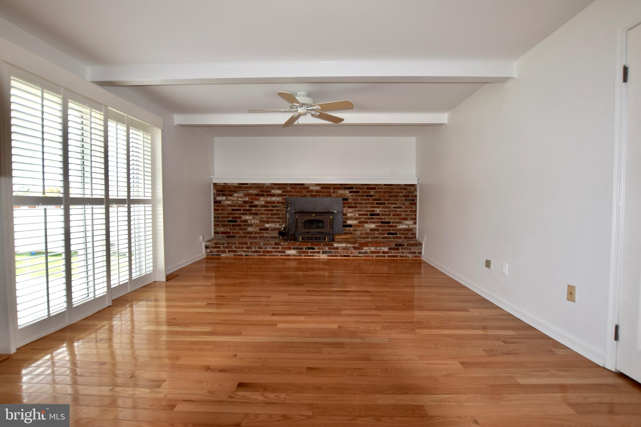 44 West Brookline Drive Laurel Springs, NJ 08021 - Photo 13 of 39 wooden floor fireplace and windows in an empty room