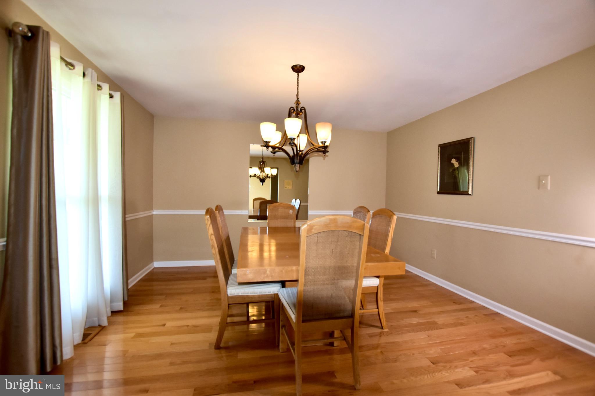 44 West Brookline Drive Laurel Springs, NJ 08021 - Photo 16 of 39 a dining room with furniture a chandelier and wooden floor