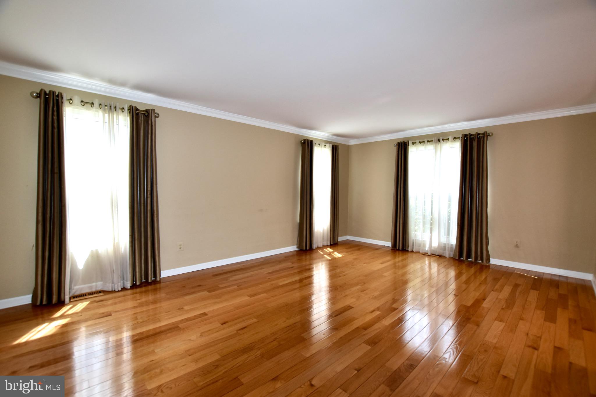 44 West Brookline Drive Laurel Springs, NJ 08021 - Photo 17 of 39 a view of an empty room with wooden floor and a window