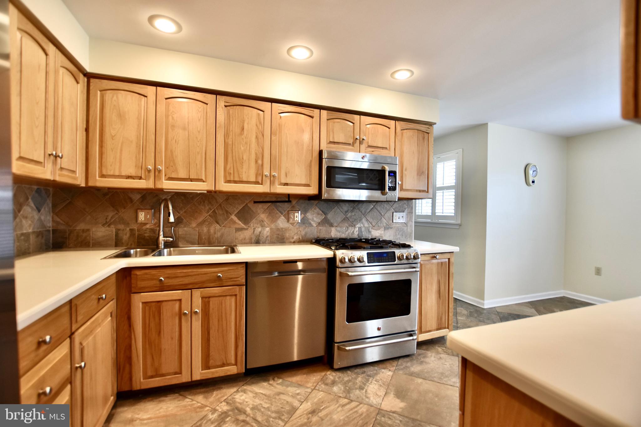 44 West Brookline Drive Laurel Springs, NJ 08021 - Photo 6 of 39 a kitchen with stainless steel appliances granite countertop a stove a sink and a microwave